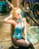 A woman in a bunny costume posing in front of a washing machine.