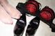 A pair of black and red lingerie and a pair of heels.